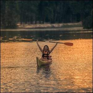 woman relaxing on the water in a kayak