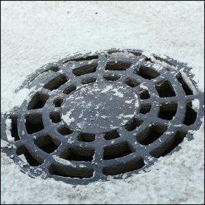 Manhole Cover covered with snow